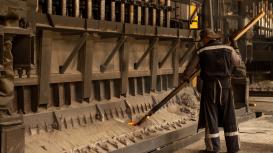 Operator handling molten metal immersion furnace